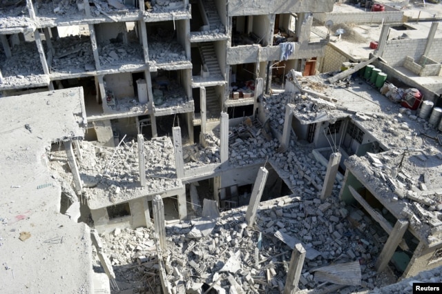 View of buildings damaged by what activists said were missiles fired by a Syrian Air Force fighter jet loyal to President Bashar al-Assad at Jessreen area in Ghouta, east of Damascus, December 2, 2012.