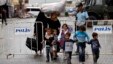 A Syrian family walks past a blast site in the town of Reyhanli of Hatay province near the Turkish-Syrian border, May 12, 2013.