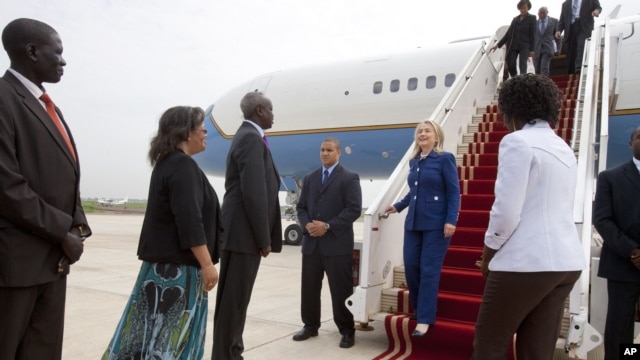 U.S. Ambassador of South Sudan Susan Page, second from left, and South Sudan Foreign Minister Nhial Deng Nhial, greet Secretary of State Hillary Rodham Clinton on her first visit to South Sudan, August 3, 2012, at Juba International Airport in Juba. 