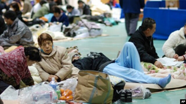 Evacuees gather in a gym in Koriyama, Japan