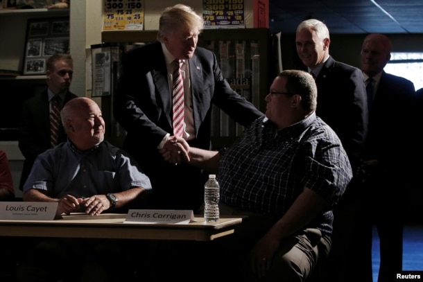 Republican nominee Donald Trump and his running mate Indiana Governor Mike Pence (back R) meet with local labor leaders and union members during a campaign stop in Brook Park, Ohio, Sept. 5, 2016.