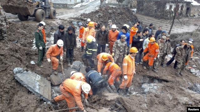 Rescuers search for victims after a landslide hit Zhenxiong county, Yunnan province, China, January 11, 2013.