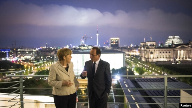 German Chancellor Angela Merkel and French President Francois Hollande speak after their joint news conference in the Chancellery in Berlin, May 15, 2012.