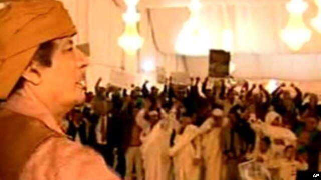 This video image broadcast on Libyan state television Sunday Feb. 20, 2011 shows longtime Libyan leader Moammar Gadhafi appearing with numerous supporters in Tripoli, Saturday Feb. 19, 2011.