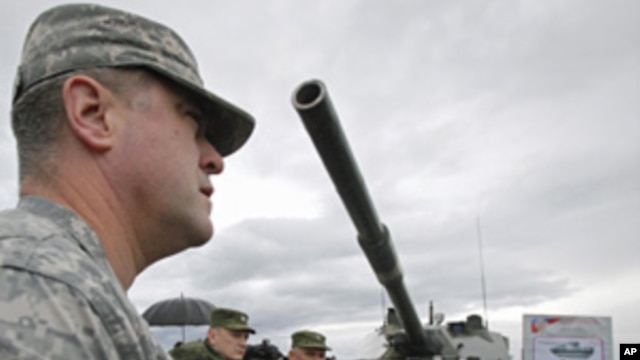 A US, OSCE military observer examines a newly added to Russia's armory 2S25 "Sprut-SD" heavy armament combat vehicle, Sept. 23, 2011.