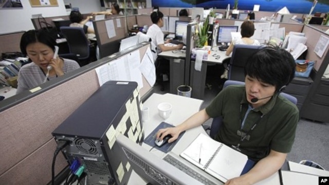 AhnLab Inc Customer Support team talk to customers on their phones at a call center in Seoul (file photo)
