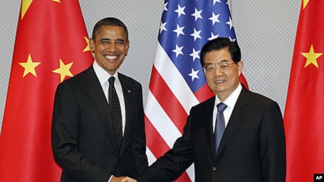 President Barack Obama, left, and Chinese President Hu Jintao shake hands to start their meeting in Seoul, South Korea, March 26, 2012.
