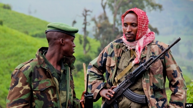 A picture taken on June 3, 2012 shows rebels of the armed force known as M23 patrolling on the hill of Kavumu in North Kivu, Democratic Republic of the Congo (DRC).