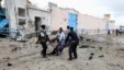 Somali government soldiers evacuate an injured man after a suicide bomb attack at a U.N. compound in Mogadishu, June 19, 2013. 