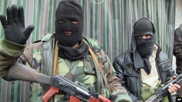 Armed members of the Free Syrian Army are seen in the western border town of Zabadani, Syria, in this undated photo, January 16, 2012.