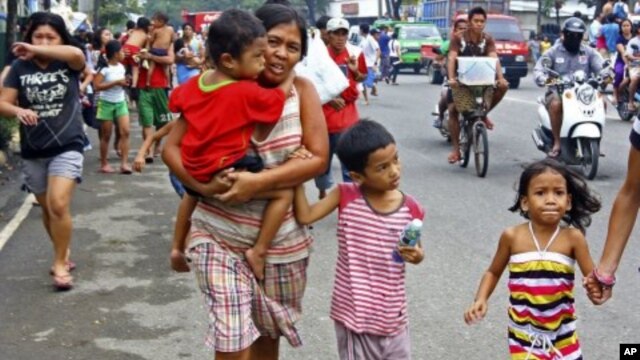 Residents rush to higher grounds following tsunami rumors due to a magnitude 6.9 earthquake which hit the island province of Cebu and other central Philippine provinces, February 6, 2012.