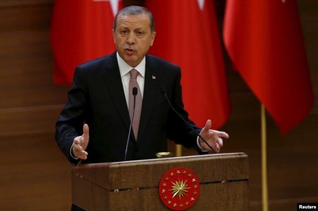 FILE - Turkish President Recep Tayyip Erdogan makes a speech during his meeting with mukhtars at the Presidential Palace in Ankara, Turkey, Nov. 26, 2015.