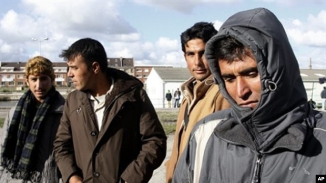 Would be Illegal immigrants to Britain stand in line waiting for a meal supplied by a humanitarian association  in Calais, France. (file photo)
