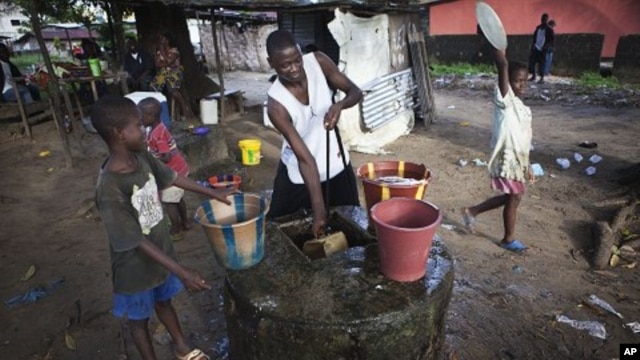 Boys collect water at a well in Liberia's capital Monrovia. (File Photo)