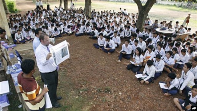 The officers of U.N.-backed genocide tribunal meet high school students at Ek Phnom district in Battambang province, as they distribute recent verdict books of Khmer Rouge leader Kaing Guek Eav, northwest of Phnom Penh, Cambodia, May 5, 2011
