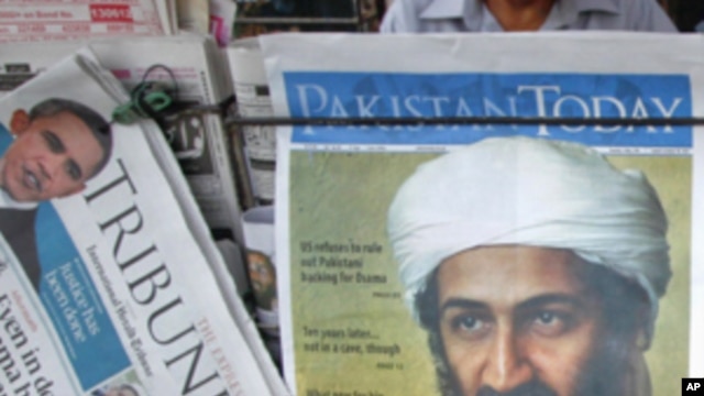 A roadside vendor sells newspapers with headlines about the death of al-Qaeda leader Osama bin Laden, in Lahore May 3, 2011.