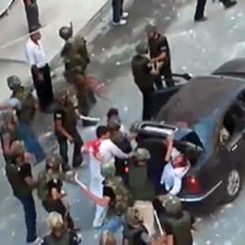 An grab taken on June 27, 2011 from footage uploaded on YouTube on June 24 allegedly shows Syrian security forces beating two men with batons and shoving them in the trunk of a car in Barza on the outskirts of Damascus (editorial content, date and locatio