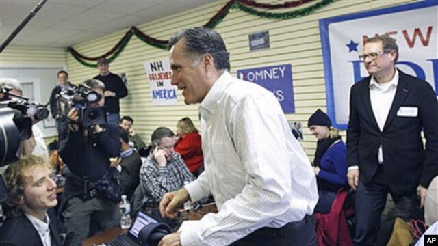 Republican presidential candidate, former Massachusetts Governor Mitt Romney, visits his campaign headquarters in Manchester, New Hampshire, January 9, 2012.