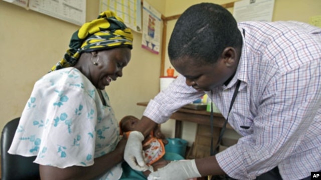 Iren Salama holds her baby Pendo as it is given an injection as part of a malaria vaccine trial at a clinic in the Kenya coastal town of Kilifi, November 23, 2010 (file photo).
