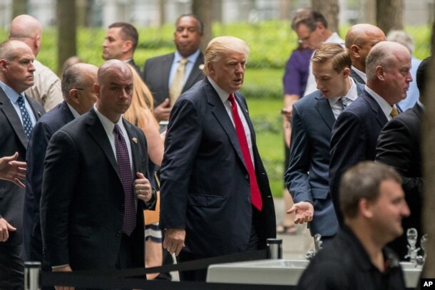 Republican presidential candidate Donald Trump, center, arrives to attend a ceremony at the National September 11 Memorial, in New York, Sept. 11, 2016, on the 15th anniversary of the Sept. 11 attacks.