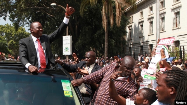 Kenya's Deputy Prime Minister Uhuru Kenyatta leaves in company of supporters after he was cleared by the  Independent Electoral and Boundaries Commission to run for the presidency in the March 4 presidential elections in capital Nairobi, January 30, 2013.