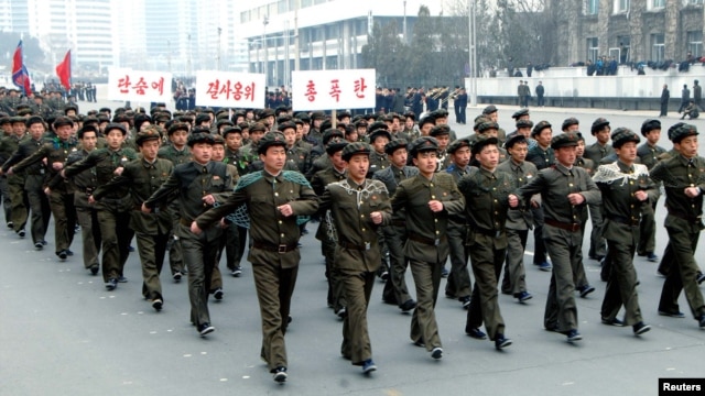 North Korean students attend a contest of singing wartime songs in chorus while marching in array, at Kim Il Sung square in Pyongyang in this picture released by the North's KCNA news agency March 17, 2013.
