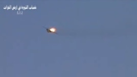 This image made from amateur video released by R.Y.E. Syria purports to show a Syrian plane downed over the eastern province of Deir el-Zour, Syria, August 13, 2012. 
