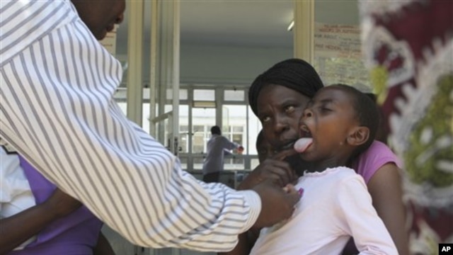 A doctor examins a child suffering from typhoid at a local infectious disease hospital in Harare, Tuesday, Nov.15, 2011. Health authorities say 207 cases of typhoid, spread by contaminated water and food, are being treated in Zimbabwe's capital after a pr