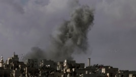 Smoke rises over the Salah al-Din neighborhood in central Aleppo, Syria, March 2, 2013.