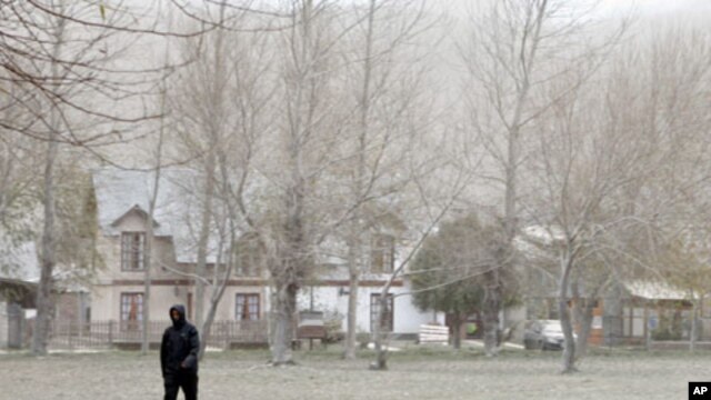 A man walks on a field covered with ash in the mountain resort of San Martin de Los Andes in Argentina's Patagonia. The volcano in the Puyehue-Cordon Caulle chain in Chile has been erupting for the past week, throwing air travel in South America into chao
