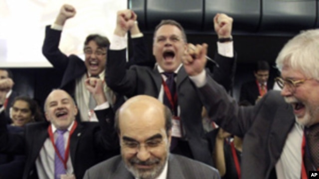 Newly elected Food and Agriculture Organization Director-General, Jose Graziano da Silva of Brazil, center, is cheered by delegates after being elected at FAO's Headquarters in Rome, Sunday, June 26, 2011.