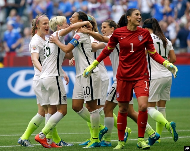 United States' Carli Lloyd (3-L) celebrates with teammates, including goalkeeper Hope Solo (1), after Lloyd scored her third goal against Japan during the first half of the Women's World Cup soccer championship in Vancouver, Canada, July 5, 2015.