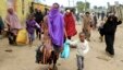 Somali families move out of their homes after they were broken into during the second day of skirmishes in the Eastleigh neighborhood of Kenya's capital Nairobi, Nov. 19, 2012. 