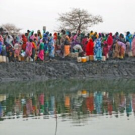 Displaced women gather to collect water from a water hole near Jamam refugee camp in South Sudan's Upper Nile State, March 10, 2012.