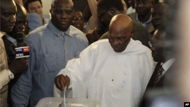 President Abdoulaye Wade casts his ballot for president at a polling station in Dakar, Senegal, Sunday, March 25, 2012.