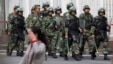 Paramilitary policemen with shields and batons patrol near the People's Square in Urumqi, China's northwestern region of Xinjiang, May 23, 2014.