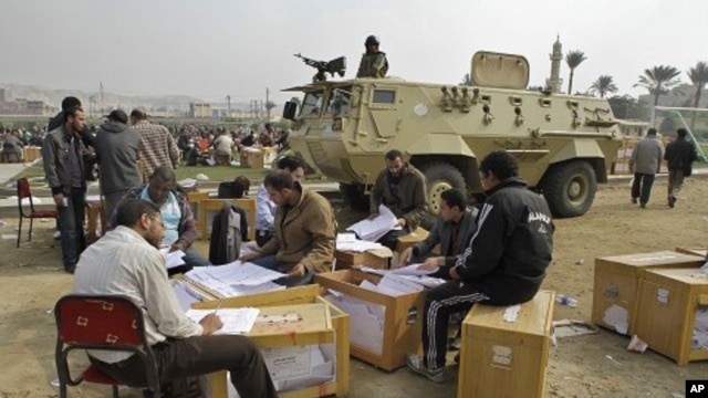 Election officials count ballots for the parliamentary elections in Cairo, Egypt, November 30, 2011.