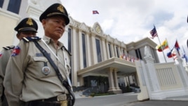 Cambodian police officers stand guard in front of the Peace Palace ahead of the ASEAN Summit and related meetings in Phnom Penh, Cambodia, November 17, 2012.