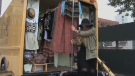 Jessie Goldenberg unloads goods from her mobile store.