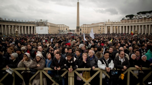 Visitors wait for the chimney smoke in St. Peter's Square during the second day of the conclave to elect a new pope, at the Vatican, Mar. 13, 2013.