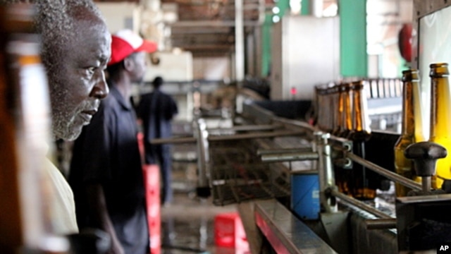 A worker monitors the bottling line at the Pampa beer factory in Bissau, Guinea-Bissau.