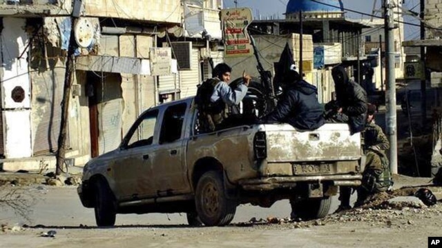 FILE - This undated file image posted on a militant website Jan. 14, 2014, shows fighters from an al-Qaida-linked Islamic State militant group in Raqqa, Syria.