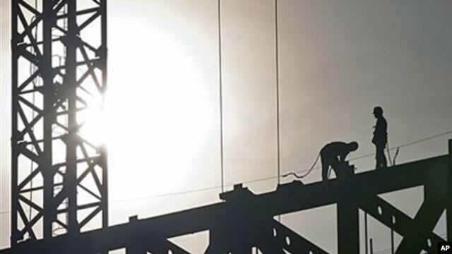 Workers are silhouetted at a building construction site while Chinese leaders scramble to shore up flagging economic growth as exports weaken, in Beijing, China, December 1, 2011.