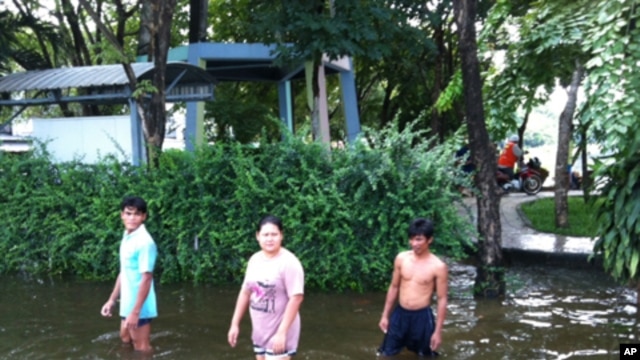 People Wade in Flooded Northwest Bangkok Neighborhood