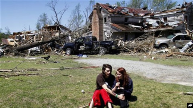 Nathaniel Ramey, left, comforts Megan Hurst at her grandmother's house in Askewville, North Carolina., Sunday, April 17, 2011 after a tornado struck Saturday