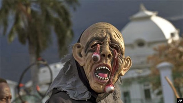A masked reveler passes the earthquake damaged National Palace during carnival celebrations in Port-au-Prince,Mar 6 2011