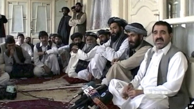 Kandahar provincial governor Ahmad Wali Karzai (R), a brother of Afghan President Hamid Karzai, talks to journalists in Kandahar in this still image taken from a April 2009 video.