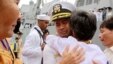 FILE - U.S. Navy Cmdr. Michael Vannak Khem Misiewicz embraces an aunt at Sihanoukville, Cambodia, upon his return to his homeland, Dec. 3, 2010. The aunt had helped arrange his adoption in the U.S. Misiewicz now has been sentenced in a bribery scandal.