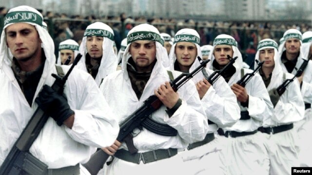 FILE - A Muslim brigade of the Bosnian Army marches in a military parade in Zenica in this 1995 photo. Muslim fighters from Afghanistan, North Africa and the Middle East joined the fighting in Bosnia in the early 1990s.