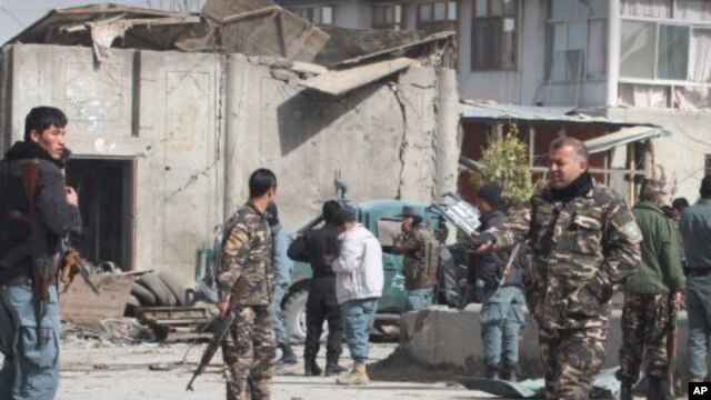 Afghan security men are seen at the scene of a suicide attack in Kandahar, south of Kabul, Afghanistan, February 5, 2012.